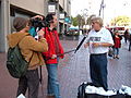 A man selling Free Tibet shirts near Justin Herman Plaza on Market Street is interviewed