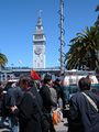 People and news media near the entrance to Justin Herman Plaza on Market Street