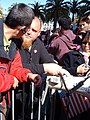 A security guard (right) warns a pro-China protester about using a megaphone to play the Chinese national anthem