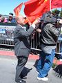 Reporter David Louie of KGO-TV (Channel 7) takes a photo while his cameraman (right) films crowds lining The Embarcadero