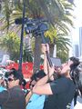 A cameraman films pro-China protesters near Justin Herman Plaza